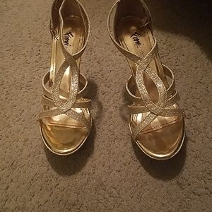 Gold speaking strapped heels practically new